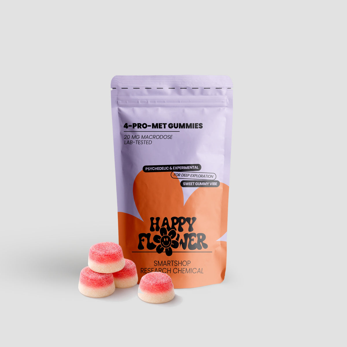 Happy Flower 4-PRO-MET Gummies 20 mg in lilafarben-korallfarbener Standbeutel-Verpackung mit vier rot-weißen Gummies im Vordergrund auf hellem Hintergrund.