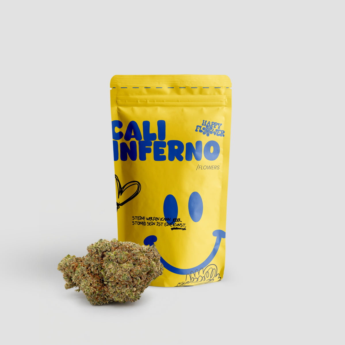 Happy Flower Cali Inferno Flowers in gelber Standbeutel-Verpackung mit mehreren Cannabisblüten im Vordergrund auf hellem Hintergrund.