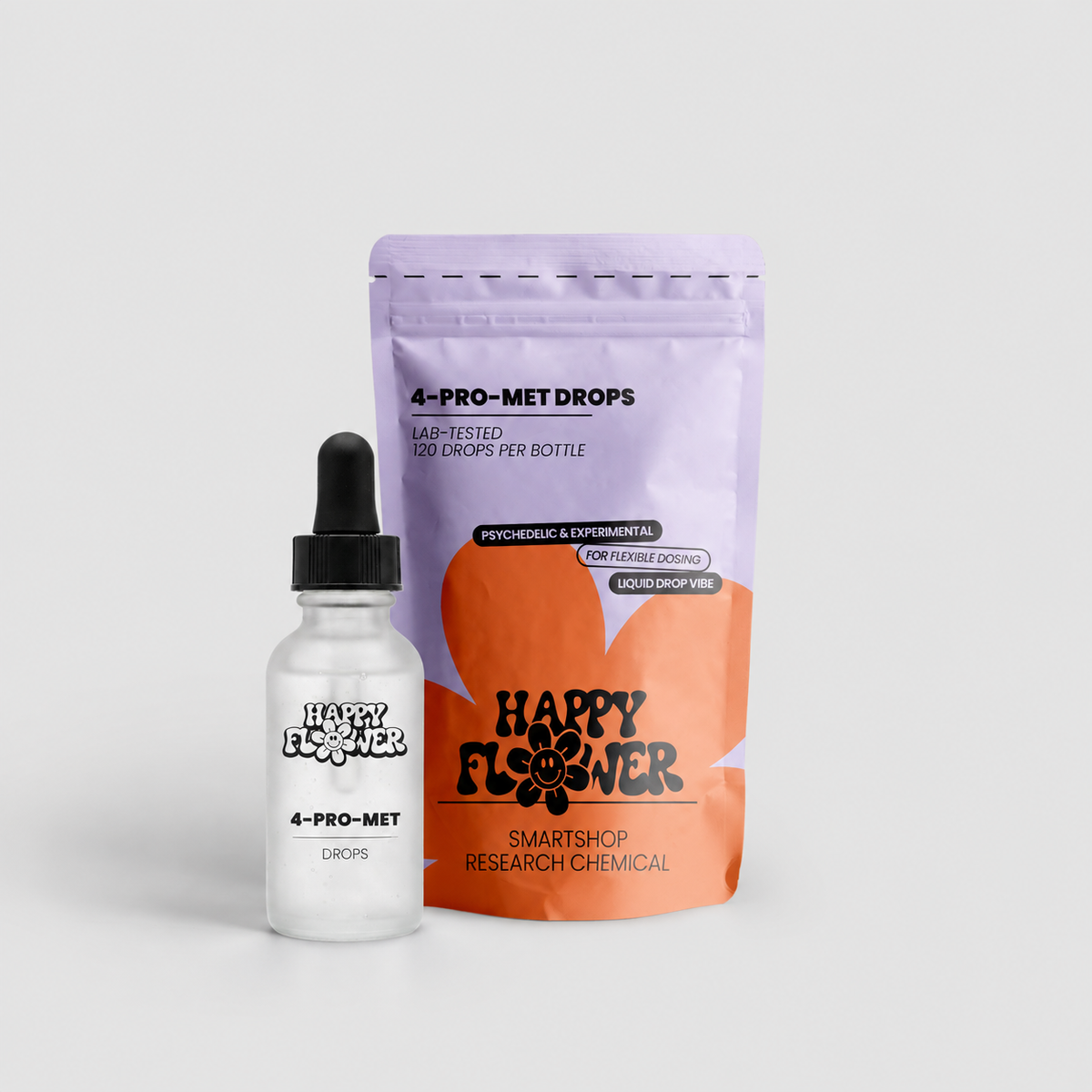 Happy Flower 4-PRO-MET Drops in lilafarben-korallfarbener Standbeutel-Verpackung mit transparenter Pipettenflasche im Vordergrund auf hellem Hintergrund.
