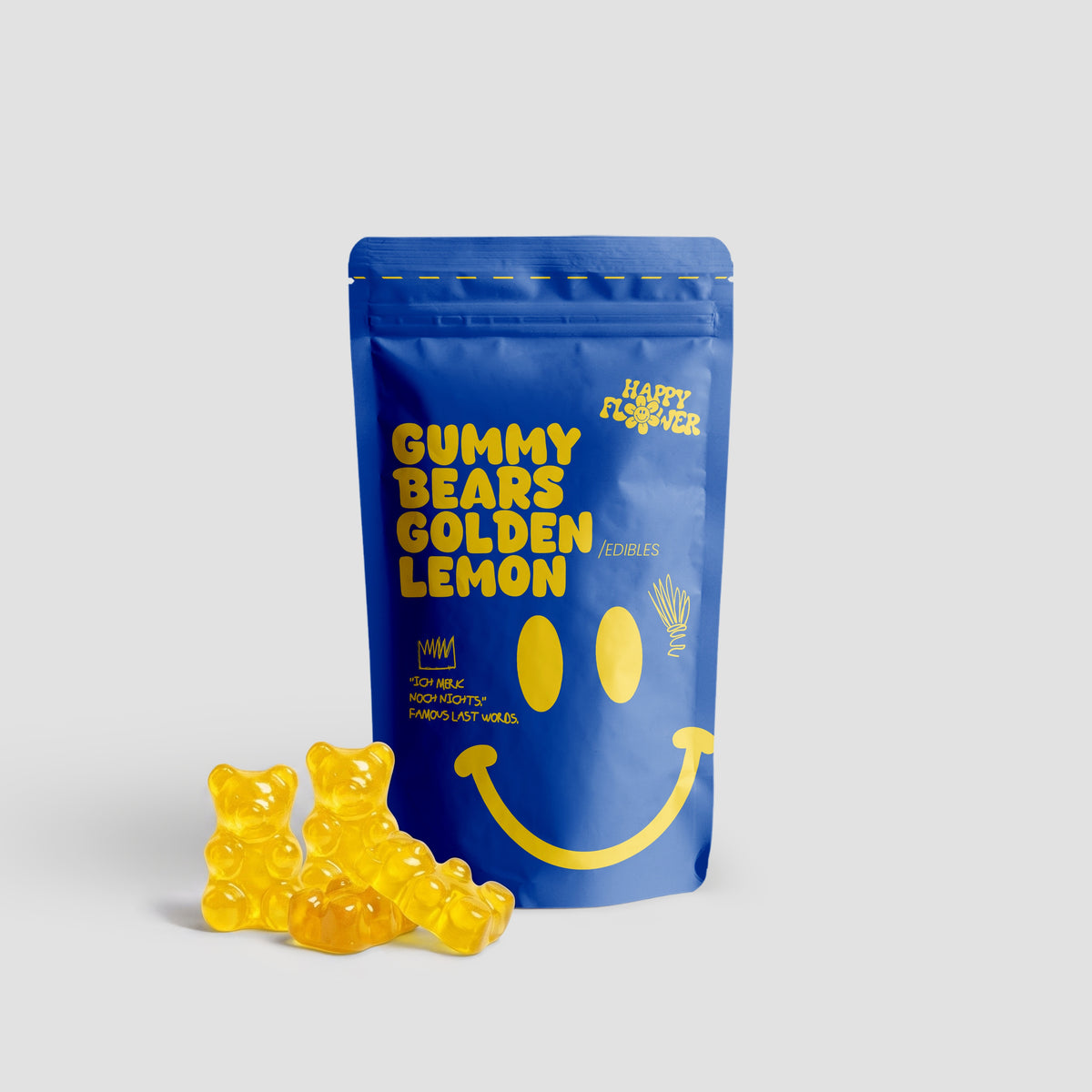Happy Flower Gummy Bears Golden Lemon Edibles in blauer Standbeutel-Verpackung mit mehreren gelben Gummibärchen im Vordergrund auf hellem Hintergrund.